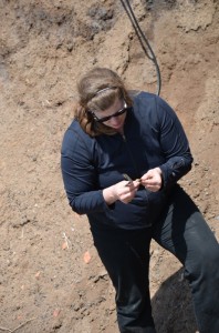 Leah Rosenmeier, MDCC Research and Interpretation Specialist, looks at some of the lithic material (i.e. rocks!) at Cape d’Or in July 2013.
